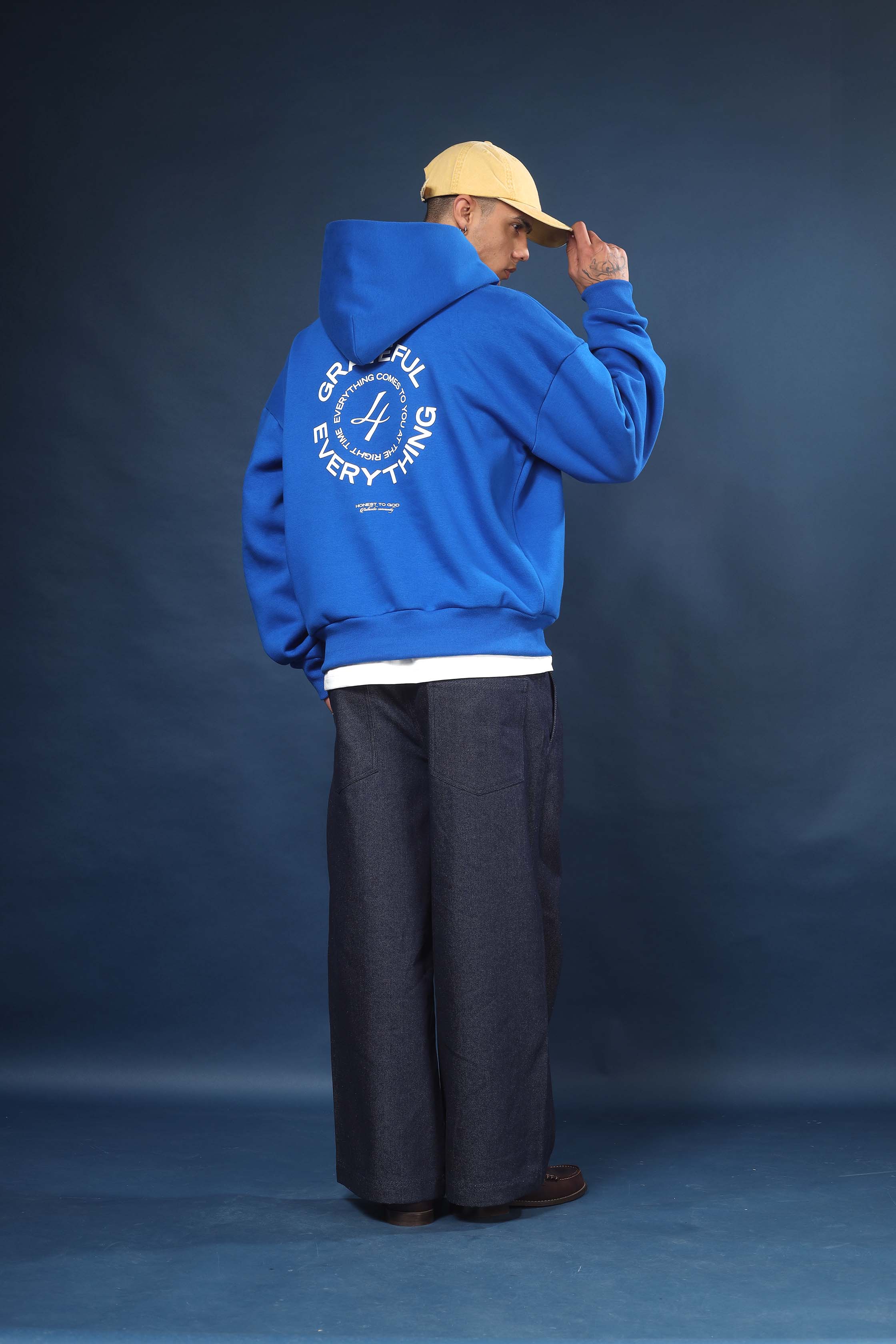 Side view of Honest to God Cobalt Blue hoodie highlighting the dropped shoulder and boxy cut.