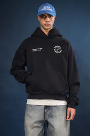 Model wearing Honest to God Black boxy hoodie for a 90s inspired international vibe.