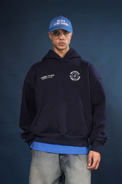 Model wearing Honest to God Navy Blue boxy hoodie for a 90s inspired international vibe.